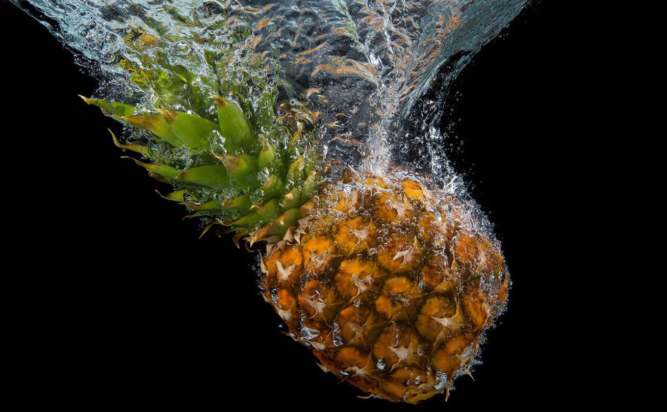 Photo of a pineapple falling into water